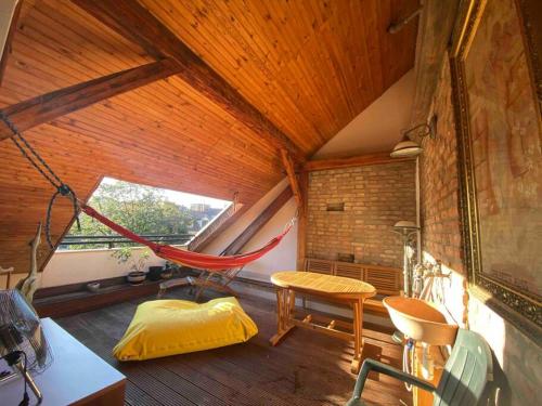 een kamer met een hangmat in een huis bij Rooftop 180m2 Loft with private SAUNA, in Bratislava