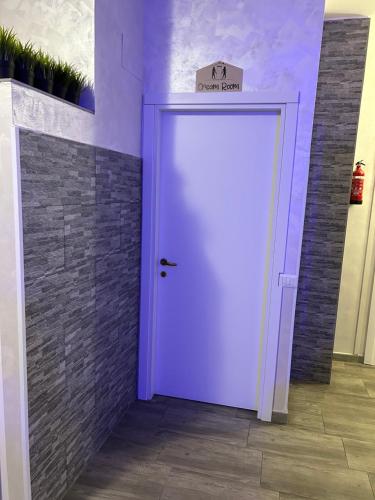 a purple door with a sign on top of it at Guest House Il Faraone in Fiumicino