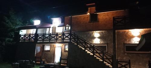 a house with a staircase in front of it at night at Apartment Country Villa MMMM-1-Camp Scepanovic in Mojkovac