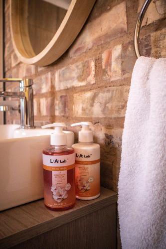 two bottles of medicine sitting on a shelf in a bathroom at Arnhem Cave Lodge in Omitara