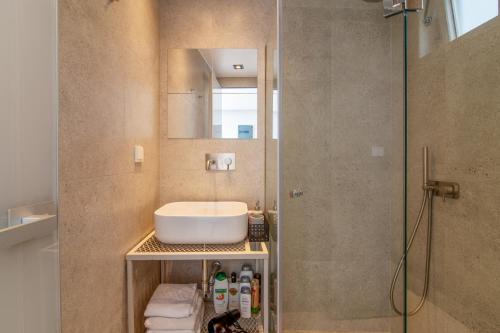 a bathroom with a sink and a shower at Kolonaki Square Parthenon Τerrace in Athens