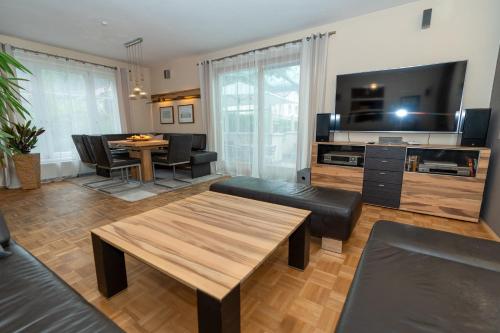 a living room with a table and a dining room at Ferienhaus Tolazzi in Arnoldstein