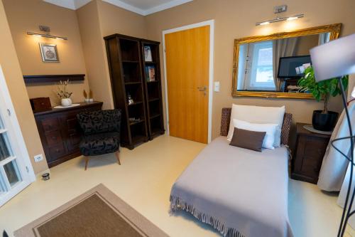 a bedroom with a bed and a desk and a window at Ferienhaus Tolazzi in Arnoldstein