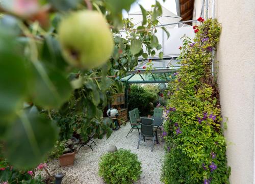 a garden with a table and chairs and flowers at Ferienhaus Tolazzi in Arnoldstein