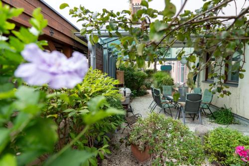 a patio with chairs and a table and flowers at Ferienhaus Tolazzi in Arnoldstein