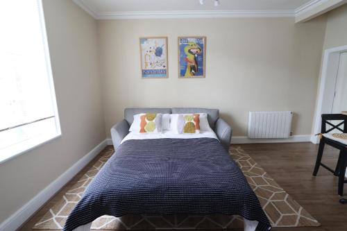 a bedroom with a bed with a blue blanket at Town View in Stourport