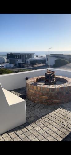 a fire pit on the roof of a building at Yzerfontein Villa Fantastica - No Loadshedding in Yzerfontein