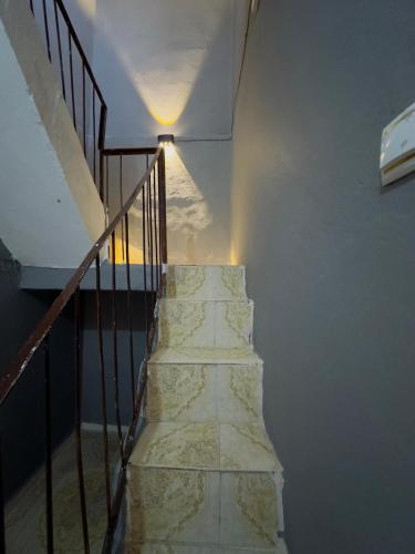 a staircase with a light on the side of a building at Manzaralı ev in Mardin