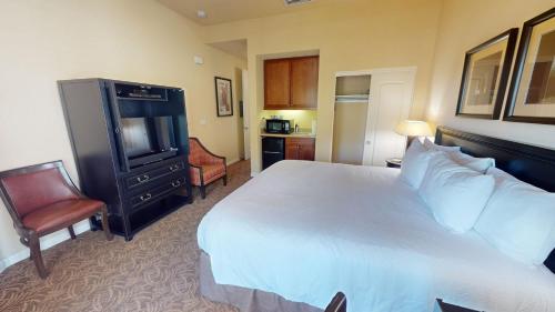 a hotel room with a large bed and a television at LV030 Private Upstairs Studio w Mountain Views in La Quinta