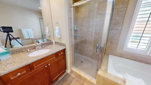 a bathroom with a shower and a sink and a tub at LV030 Private Upstairs Studio w Mountain Views in La Quinta