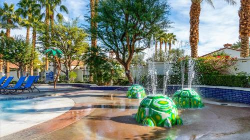 a fountain in a park with palm trees at LV030 Private Upstairs Studio w Mountain Views in La Quinta