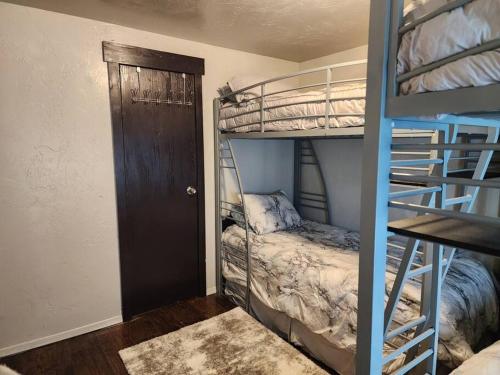 a room with two bunk beds and a door at Animal Village in Kalispell