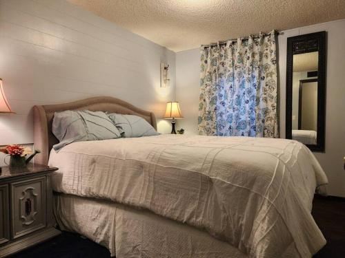a bedroom with a large bed and a window at Animal Village in Kalispell