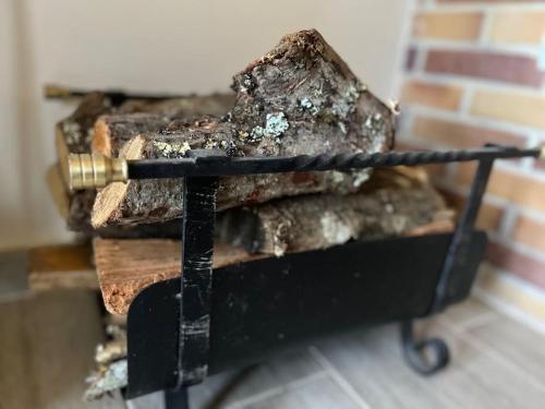 a pile of fire wood with a cannon on top at La puerta de Fredo in Arboleya