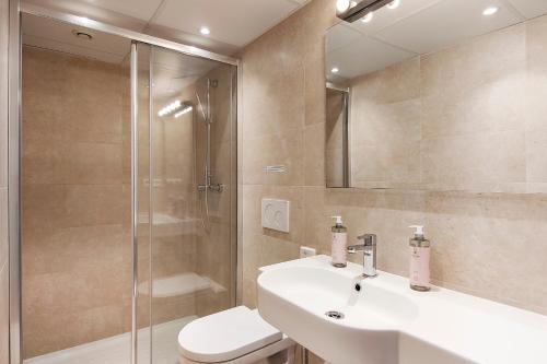 a bathroom with a toilet and a sink and a shower at Aparthotel AMMI Nice Massena - ex Ajoupa in Nice