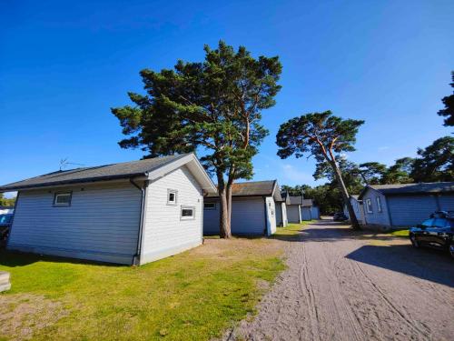 a row of garages on a dirt road at Strandbyn - Destination Råbocka in Ängelholm