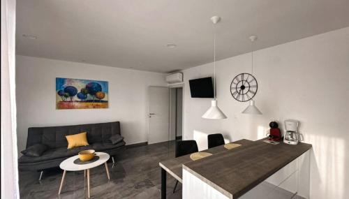 a living room with a couch and a table at Apartment Lantana Hvar in Hvar