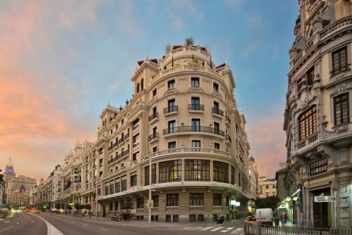 a large building on a city street with a sky at The Principal Madrid, Small Luxury Hotels in Madrid