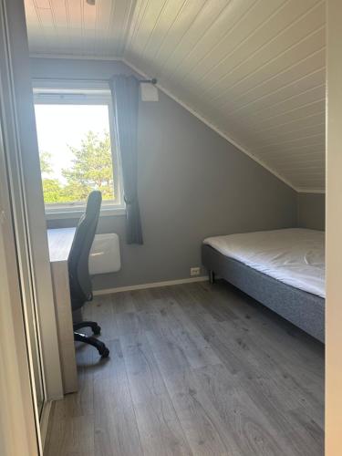a room with a bed and a desk and a window at Nørvegata 64 in Ålesund