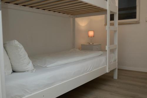 a white bunk bed in a room with a lamp at Ferienwohnung Endingen am Kaiserstuhl in Endingen
