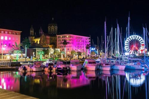 a group of boats docked in a marina at night at Studio Le Santa-Maria - Frejus Plage in Fréjus
