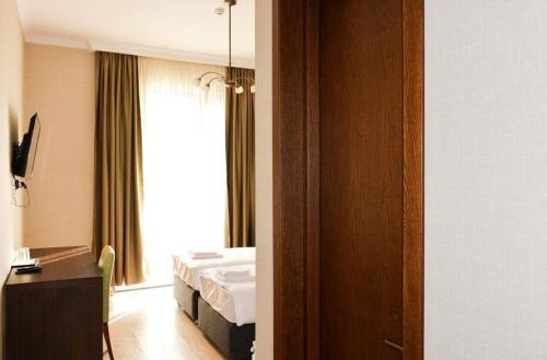 a hotel room with a bed and a window at Eleon Boutique Hotel in Tbilisi City