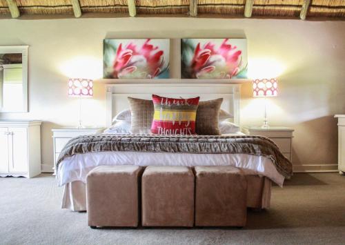 a bedroom with a large bed with a headboard at Siesta Guesthouse & Wedding Venue - Frankfort in Frankfort