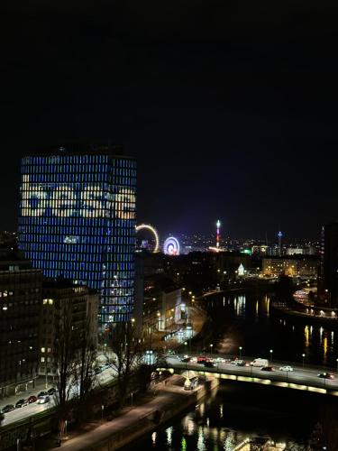 a view of a city at night with a bridge at Center Apartment with 360° Rooftop in Vienna