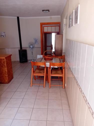 a kitchen with a table and chairs in a room at T2 N16 Ref 006 in Tavira