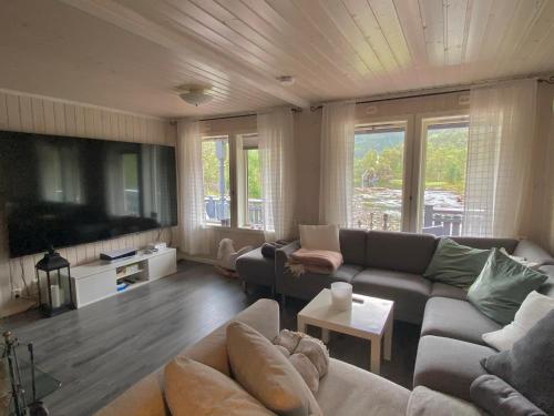 a living room with a couch and a table at Idyllisk sted for store og små in Narvik