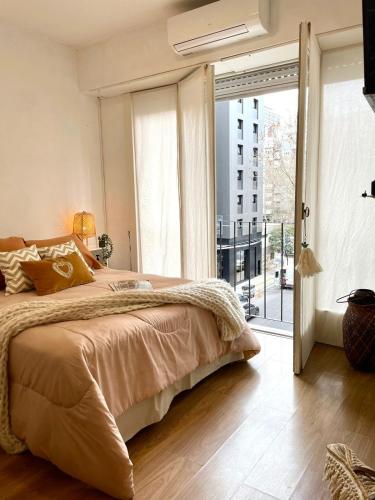 una camera con un grande letto e una grande finestra di Departamento excelente ubicación a Mar del Plata