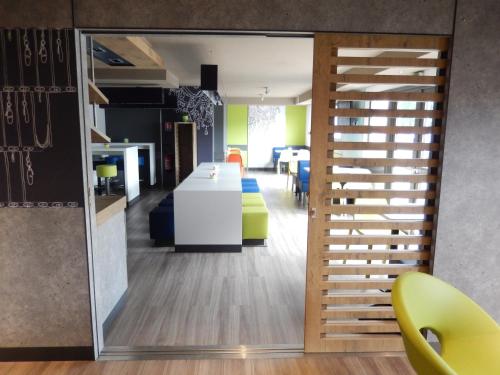 an open office with a view of a desk and chairs at ibis Budget Pau Est in Pau