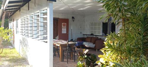 a patio with a couch and a table in a room at Chez Guy , chambre privée in Tiputa