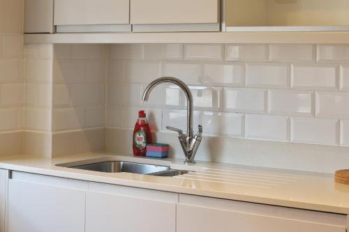 a kitchen counter with a sink at Luxury Modern 2-Bed Apartment - City Centre, FREE Netflix, Pet Friendly in Sheffield