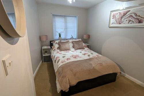 a bedroom with a bed in a white room at Turtle Dove Apartment in Oxford