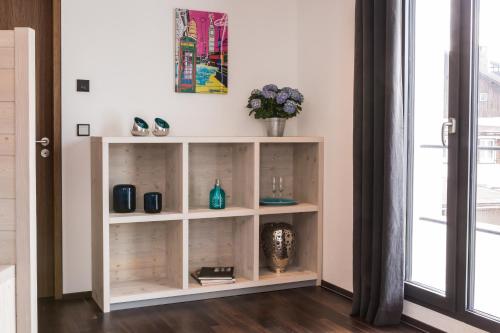 a white book shelf in a room with a window at N6 Oberstdorf in Oberstdorf