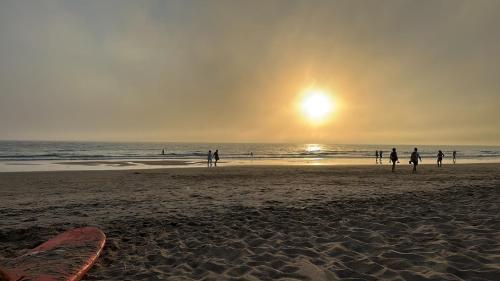 a group of people on the beach at sunset at Marina Zahara in Zahara de los Atunes