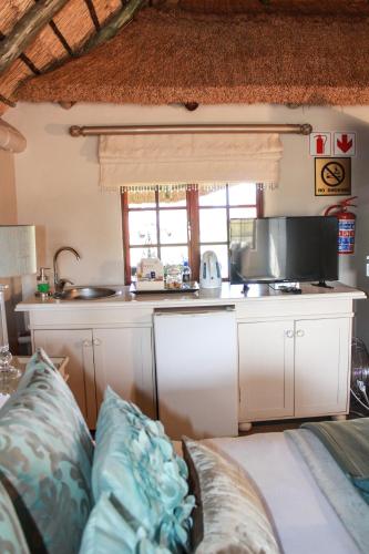 a kitchen with a couch in a room at Siesta Guesthouse & Wedding Venue - Frankfort in Frankfort