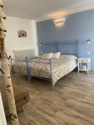 a bedroom with a bed and a wooden floor at Corte del Lago in Colico