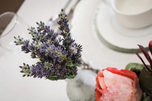 a vase filled with purple flowers on a table at Siesta Guesthouse & Wedding Venue - Frankfort in Frankfort