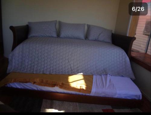 a bedroom with a bed with blue pillows at Cabañas del Puerto in Puerto Montt