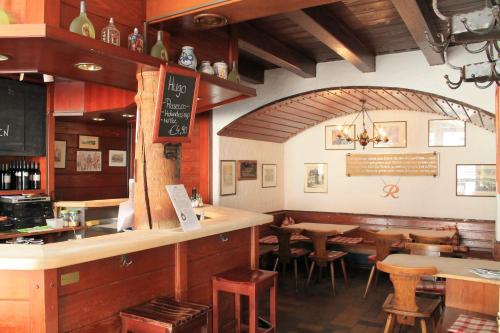 a restaurant with a bar and tables and chairs at Steichele Hotel & Weinrestaurant in Nuremberg