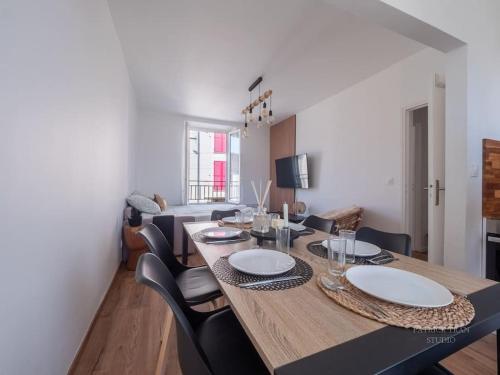 a dining room with a wooden table and chairs at Logement pour 8 personnes près de Disney & Paris in Chanteloup-en-Brie