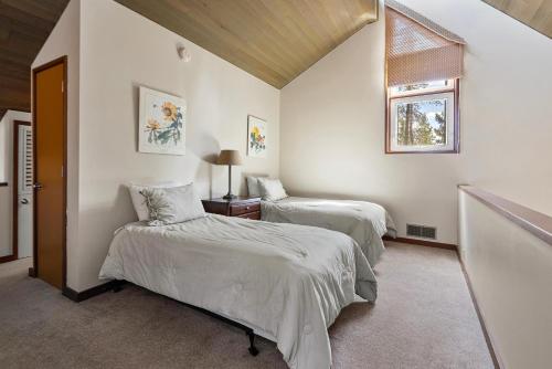 a bedroom with two beds and a window at 26 Mountain View Lodge - Meredith Lodging in Bend