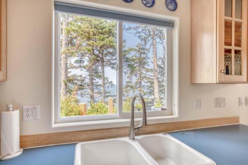 a kitchen with a sink and a window at Neskowin Lookout in Neskowin