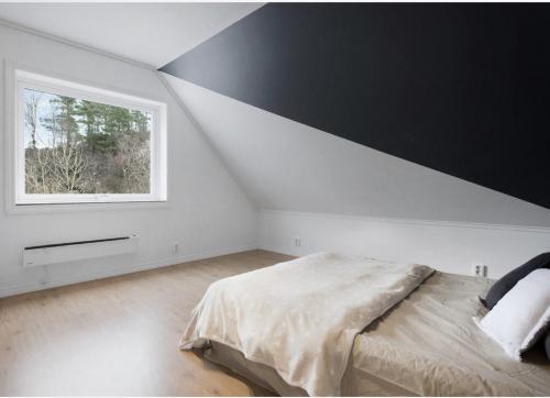 a bedroom with a large bed and a window at 5-Bedroom Apartment in Åsane, Bergen in Bergen