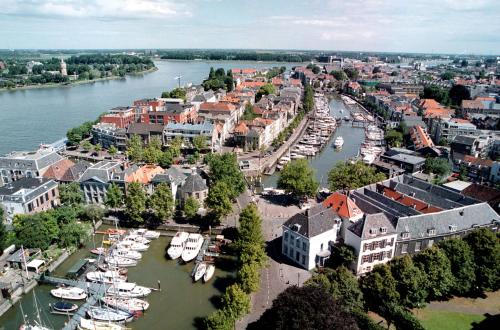 an aerial view of a city with boats in the water at Postillion Hotel Dordrecht in Dordrecht