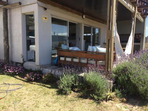 a porch with a bench on the side of a house at La Toscana 1 in Piriápolis