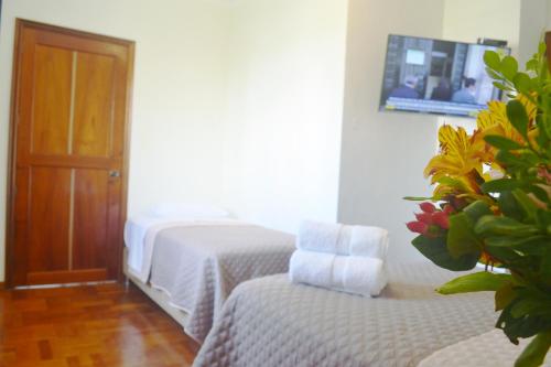 a bedroom with a bed and a chair and a door at Casa Rodas in Lima
