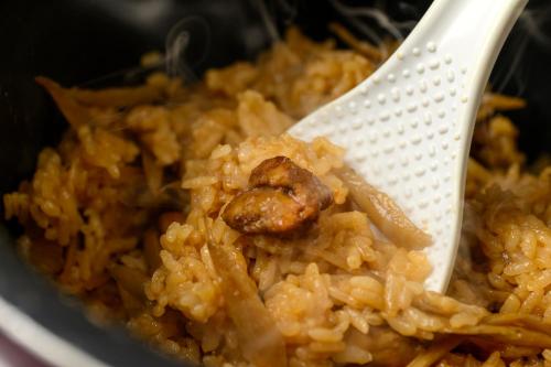 a white spoon in a bowl of rice with meat at Hotel Forza Oita in Oita